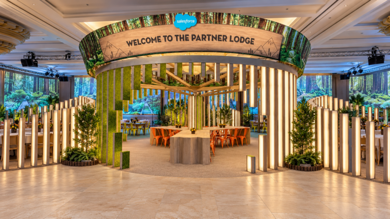 Enhanced visualization of the Dreamforce Partner Lodge, with a circular timber structure, illuminated fins and communal table.